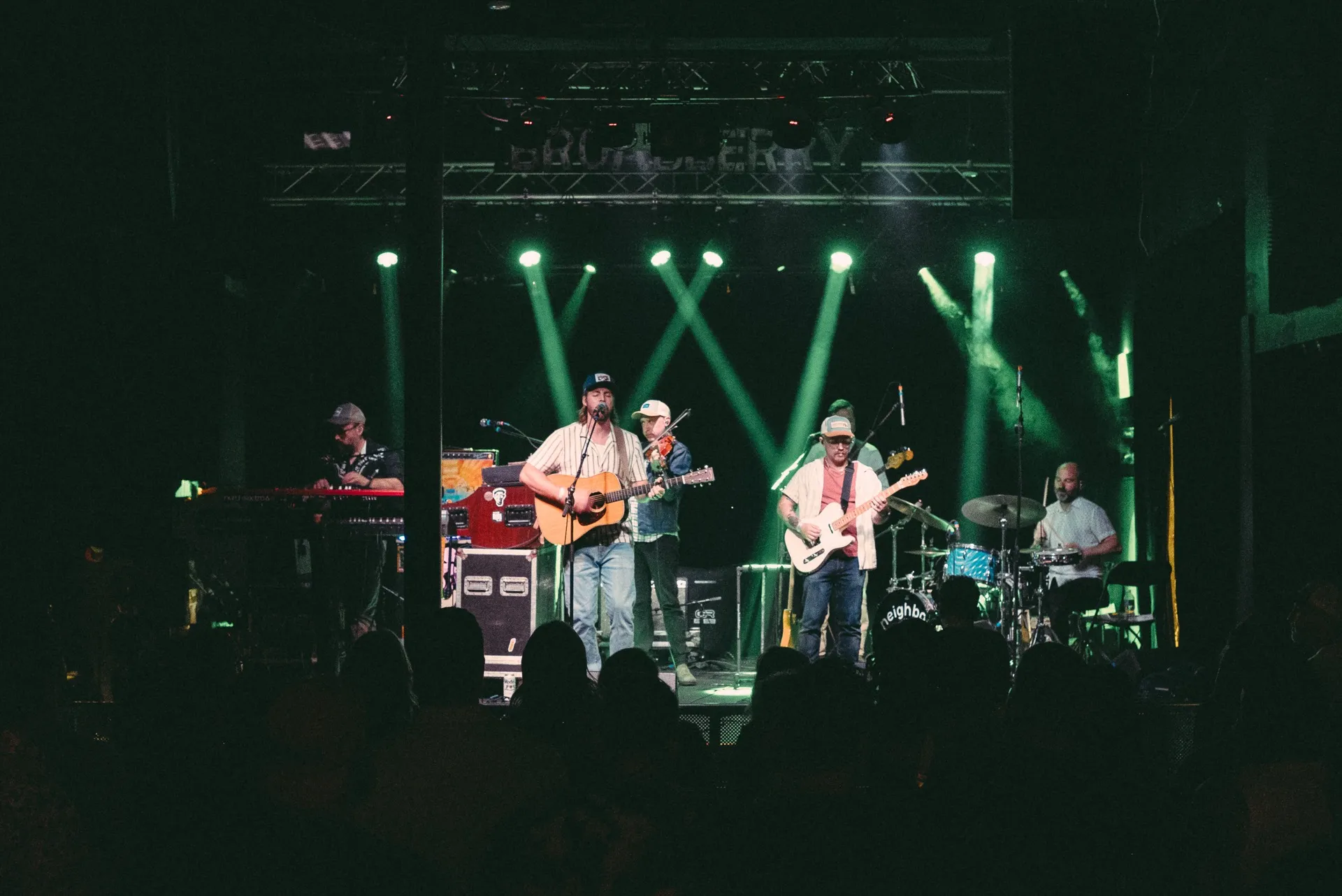 Big Holler performing live as a full band on a green-lit stage at The Broadberry